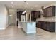 Spacious kitchen boasts a large island, stainless steel appliances, and stylish dark cabinetry at 13 Knotty Pine Lane, Clayton, NC 27520