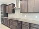 Modern kitchen featuring granite countertops, stainless steel appliances, dark cabinetry, and hardwood floors at 13 Knotty Pine Lane, Clayton, NC 27520