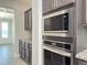 Kitchen featuring dark cabinets, granite countertops, tile backsplash, and stainless steel appliances at 13 Knotty Pine Lane, Clayton, NC 27520