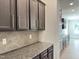 Kitchen featuring dark cabinets, granite countertops, tile backsplash, and stainless steel appliances at 13 Knotty Pine Lane, Clayton, NC 27520
