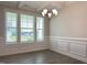 Living room with hardwood floors, white trim, a modern chandelier, and view to the front yard at 13 Knotty Pine Lane, Clayton, NC 27520