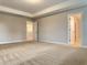 Spacious primary bedroom with neutral walls, carpet and an open doorway at 13 Knotty Pine Lane, Clayton, NC 27520