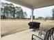 The backyard patio features an outdoor grill, perfect for barbecues and outdoor dining with Gathering and friends at 13 Knotty Pine Lane, Clayton, NC 27520