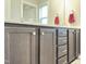 Bathroom vanity with stained cabinets, double sinks, and chrome hardware at 13 Knotty Pine Lane, Clayton, NC 27520