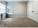 This is a bright bedroom featuring a work station and ample natural light from the window, complemented by plush carpeting at 13 Knotty Pine Lane, Clayton, NC 27520