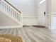 Bright entryway features wood-look flooring, white trim and a front door at 13 Knotty Pine Lane, Clayton, NC 27520