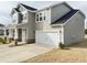 This well-maintained home features a two-car garage, a welcoming front porch, and tidy landscaping at 13 Knotty Pine Lane, Clayton, NC 27520