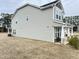 Exterior of home shows light gray vinyl siding, a level yard, patio, and other neighborhood homes in the distance at 13 Knotty Pine Lane, Clayton, NC 27520