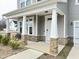 Inviting front porch with stylish stone pillars and comfortable seating, perfect for relaxing outdoors at 13 Knotty Pine Lane, Clayton, NC 27520