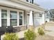 Inviting front porch with stylish stone pillars and comfortable seating, perfect for relaxing outdoors at 13 Knotty Pine Lane, Clayton, NC 27520