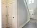 Bright hallway features wood-look flooring, white trim, and doors to multiple rooms at 13 Knotty Pine Lane, Clayton, NC 27520