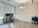 Bright home office features white trim, gray flooring, a desk, a piano and natural light at 13 Knotty Pine Lane, Clayton, NC 27520