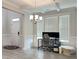 Bright home office features white trim, gray flooring, a desk and natural light at 13 Knotty Pine Lane, Clayton, NC 27520