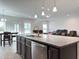 This spacious kitchen island boasts a sink, dishwasher, and granite countertops, ideal for meal prep and casual dining at 13 Knotty Pine Lane, Clayton, NC 27520