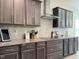 This kitchen features dark brown cabinets, stainless steel appliances, and granite countertops, creating a sleek and modern cooking space at 13 Knotty Pine Lane, Clayton, NC 27520