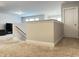 View of the landing with freshly painted white walls, wooden handrails and carpeted floors at 13 Knotty Pine Lane, Clayton, NC 27520