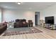 Open living area boasts neutral walls and a large brown sofa at 13 Knotty Pine Lane, Clayton, NC 27520
