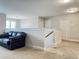 Spacious loft featuring neutral walls, plush carpet and an inviting black leather couch at 13 Knotty Pine Lane, Clayton, NC 27520
