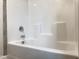 A shower and tub combination features tile surround and chrome fixtures at 13 Knotty Pine Lane, Clayton, NC 27520