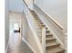 Bright staircase features carpeted steps, a white railing and wood handrail at 13 Knotty Pine Lane, Clayton, NC 27520