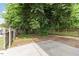 Backyard with a privacy fence, mature trees, and a gravel area at 1314 S East St, Raleigh, NC 27601