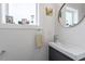 Stylish half bath with a vanity, mirror, and a window providing natural light at 1314 S East St, Raleigh, NC 27601