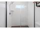Modern walk-in shower with sleek glass door and floor-to-ceiling tile at 1314 S East St, Raleigh, NC 27601