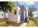 Modern two-story home featuring a rooftop deck, blue siding, and a manicured lawn at 1314 S East St, Raleigh, NC 27601