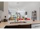 Bright kitchen with stone countertops, stainless steel appliances, and open view to the living room at 1314 S East St, Raleigh, NC 27601