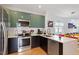 Modern kitchen boasting stainless steel appliances and a peninsula overlooking the living area at 1314 S East St, Raleigh, NC 27601