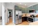 Modern kitchen featuring stainless steel appliances and sleek cabinets with bar access at 1314 S East St, Raleigh, NC 27601