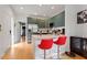 Modern kitchen featuring stainless steel appliances, a breakfast bar, and wood flooring at 1314 S East St, Raleigh, NC 27601