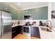 Modern kitchen with stainless steel appliances and dark cabinets with light quartz countertops at 1314 S East St, Raleigh, NC 27601