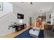 Open-concept living area with hardwood floors, TV, and view of the dining and kitchen areas at 1314 S East St, Raleigh, NC 27601