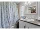 Bathroom featuring a patterned shower curtain, window, sink, and white vanity with a gray countertop at 1355 Sykes Rd, Spring Hope, NC 27882