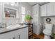 Bright bathroom featuring wood flooring, a gray countertop, decorative shelving, and white cabinets at 1355 Sykes Rd, Spring Hope, NC 27882