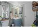 Bathroom with sink, decor, mirror, cabinet, toilet, and a hanging plant at 1355 Sykes Rd, Spring Hope, NC 27882