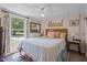 Bright bedroom with a window, decor, bed, and a ceiling fan at 1355 Sykes Rd, Spring Hope, NC 27882