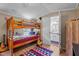 Fun bedroom featuring a bunk bed with a wooden frame and an adjacent bathroom at 1355 Sykes Rd, Spring Hope, NC 27882