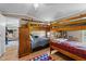 Bedroom with bunk beds, storage, and a view of the adjacent living space at 1355 Sykes Rd, Spring Hope, NC 27882