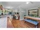 Inviting dining area with a wooden table, bench seating, and views into the kitchen at 1355 Sykes Rd, Spring Hope, NC 27882