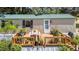 Delightful wooden deck with potted plants and a table, creating a cozy outdoor living space at 1355 Sykes Rd, Spring Hope, NC 27882