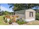 Exterior with a charming wooden deck and entryway, complemented by vibrant landscaping and potted plants at 1355 Sykes Rd, Spring Hope, NC 27882