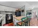 Functional kitchen with white cabinets, black appliances, and an island with bar seating at 1355 Sykes Rd, Spring Hope, NC 27882
