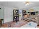 Open-concept living room with hardwood floors, modern furnishings, and direct access to kitchen at 1355 Sykes Rd, Spring Hope, NC 27882
