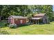 Property featuring a red outbuilding, a rustic barn, and a well-maintained yard at 1355 Sykes Rd, Spring Hope, NC 27882