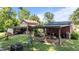 Outdoor recreational area with swings, fire pit, and diverse outbuildings for hobbies or storage at 1355 Sykes Rd, Spring Hope, NC 27882