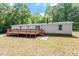 Exterior of house featuring a spacious backyard and deck, ideal for outdoor entertaining and enjoying nature's tranquility at 141 S Creek Dr, Louisburg, NC 27549
