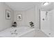 Primary bathroom featuring a soaking tub, shower and picture frame artwork at 141 S Creek Dr, Louisburg, NC 27549