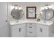 Double vanity bathroom featuring modern fixtures, white cabinetry and ample mirror space at 141 S Creek Dr, Louisburg, NC 27549